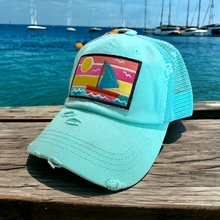 Load image into Gallery viewer, Aqua mesh high ponytail trucker hat with a rectangle embroidered patch with a sailboat and sunset scene