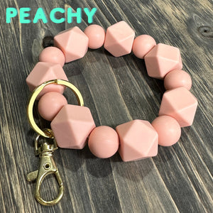 Large Peachy Silicone keychain with hexagon and round silicone beads and gold hardware.