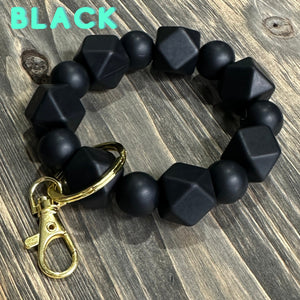 Large black Silicone keychain with hexagon and round silicone beads and gold hardware.