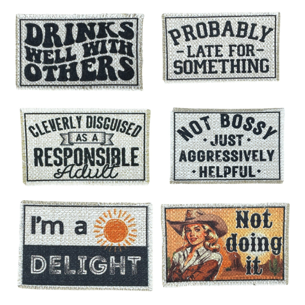 A picture of six patches: Drinks well with others, probably late for something, cleverly disguised as a responsible adult, not bossy just aggressively helpful, I'm a delight, not doing it