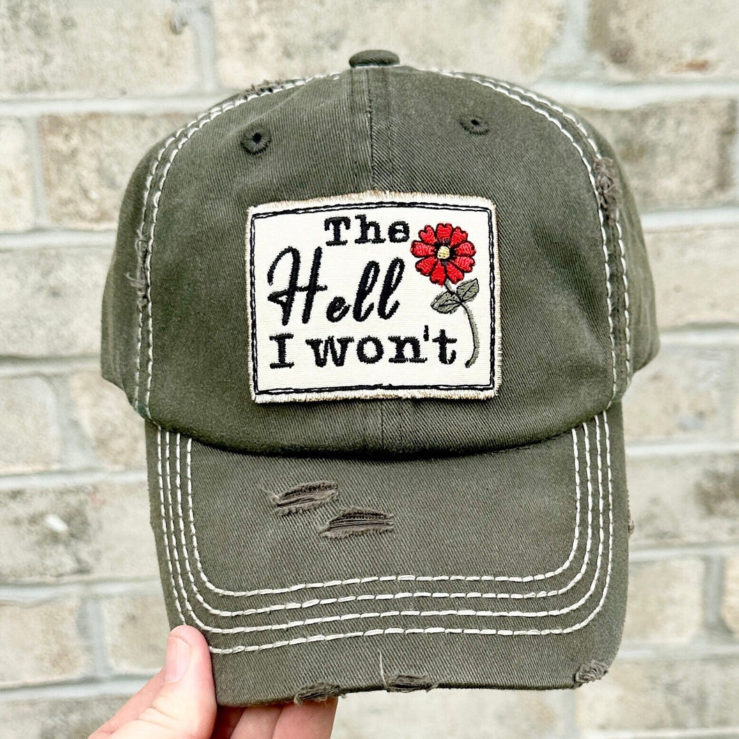 The Hell I Won't Embroidered patch hat. The hat is olive green. The patch has a red flower on it.