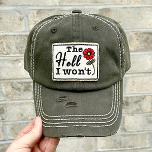 The Hell I Won&#39;t Embroidered patch hat. The hat is olive green. The patch has a red flower on it.