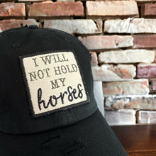 Load image into Gallery viewer, black mesh baseball hat with an embroidered patch that says, &quot;I will not hold my horses&quot;. The patch border is black and the words are olive green and black.
