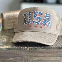 Load image into Gallery viewer, Tan trucker hat with USA printed on the front in a vintage red, white and blue.