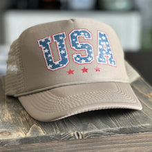 Load image into Gallery viewer, Tan trucker hat with USA printed on the front in a vintage red, white and blue.
