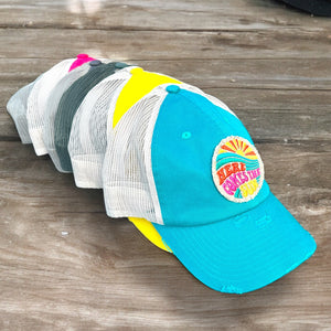 all of the hat colors together: turquoise, yellow, camo, dark gray, dark pink, and ivory