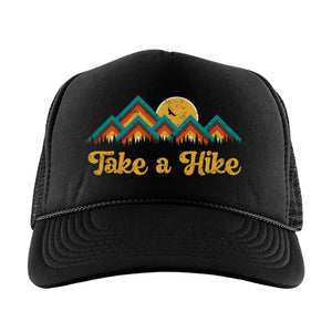 Black high profile foam trucker hat with a colorful mountain image with the words, Take a Hike in yellow retro font