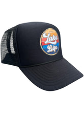 Load image into Gallery viewer, Black high profile rope trucker hat with a colorful round Lake LIfe graphic printed on the front. Lake life is printed in white cursive bubble font. The colors in the background are in a strip pattern. Blues, yellows, reds