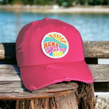 Load image into Gallery viewer, A dark pink mesh baseball hat with cotton front and rim. 6 Panels. Distressed. It has a round 2.5 inch white fabric patch that is hand frayed. It says, &quot;Here Comes the Sun&quot; in bright colors - orange, yellow, pink, aqua, blue