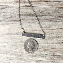 Load image into Gallery viewer, Silver hand stamped bar necklace with mountains and pine trees