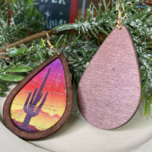 Load image into Gallery viewer, Dark wood inlet teardrop earrings with painted cactus and desert sunset background. Bright and vibrant colrors - reddiish bround, red, yellow, orange, pink, purple