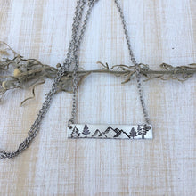 Load image into Gallery viewer, Silver hand stamped bar necklace with mountains and pine trees