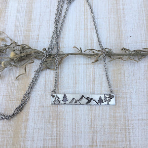 Silver hand stamped bar necklace with mountains and pine trees