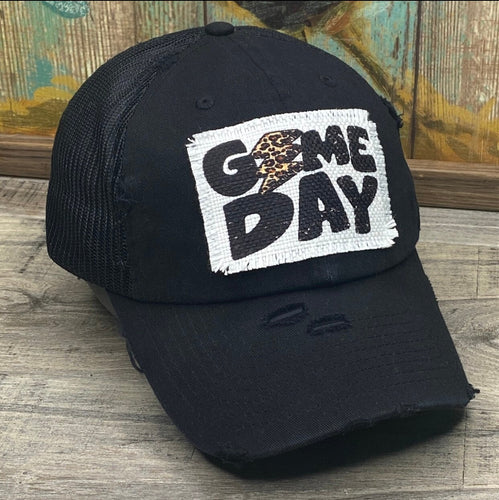 Black Mesh low profile and unstructured baseball hat. It has a white rectangle frayed edge patch that says, 