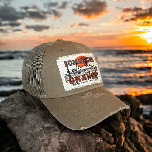 Something in the orange patch hat.
