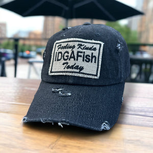 A black denim dad hat with a fabric Feeling Kinda IDGAFish Today Patch. The hat is slightly distressed.