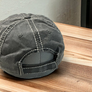 The back of a vintage gray 100% cotton distressed cap with white stitching and velcro strap closure
