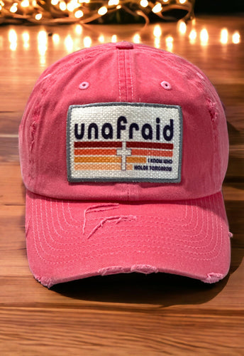 Embroidered edge patch hat. The rectangle patch says, "unafraid, I know who holds tomorrow" with a retro line design and cross in the middle. The image is printed onto the patch and edge is embroidered.