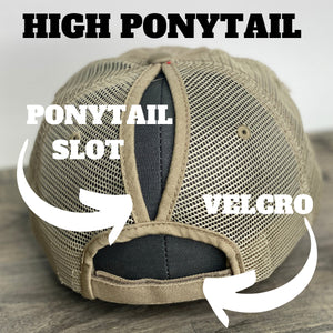 Backside of the high ponytail hat showing the ponytail slot and velcro strap closure.