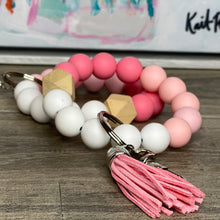 Load image into Gallery viewer, Dark pink, baby pink, and white silicone beads wristlet keychain with a light wood hexagon accent bead, pink tassel, and silver keyring