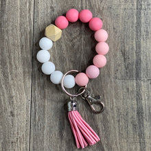 Load image into Gallery viewer, Dark pink, baby pink, and white silicone beads wristlet keychain with a light wood hexagon accent bead, pink tassel, and silver keyring